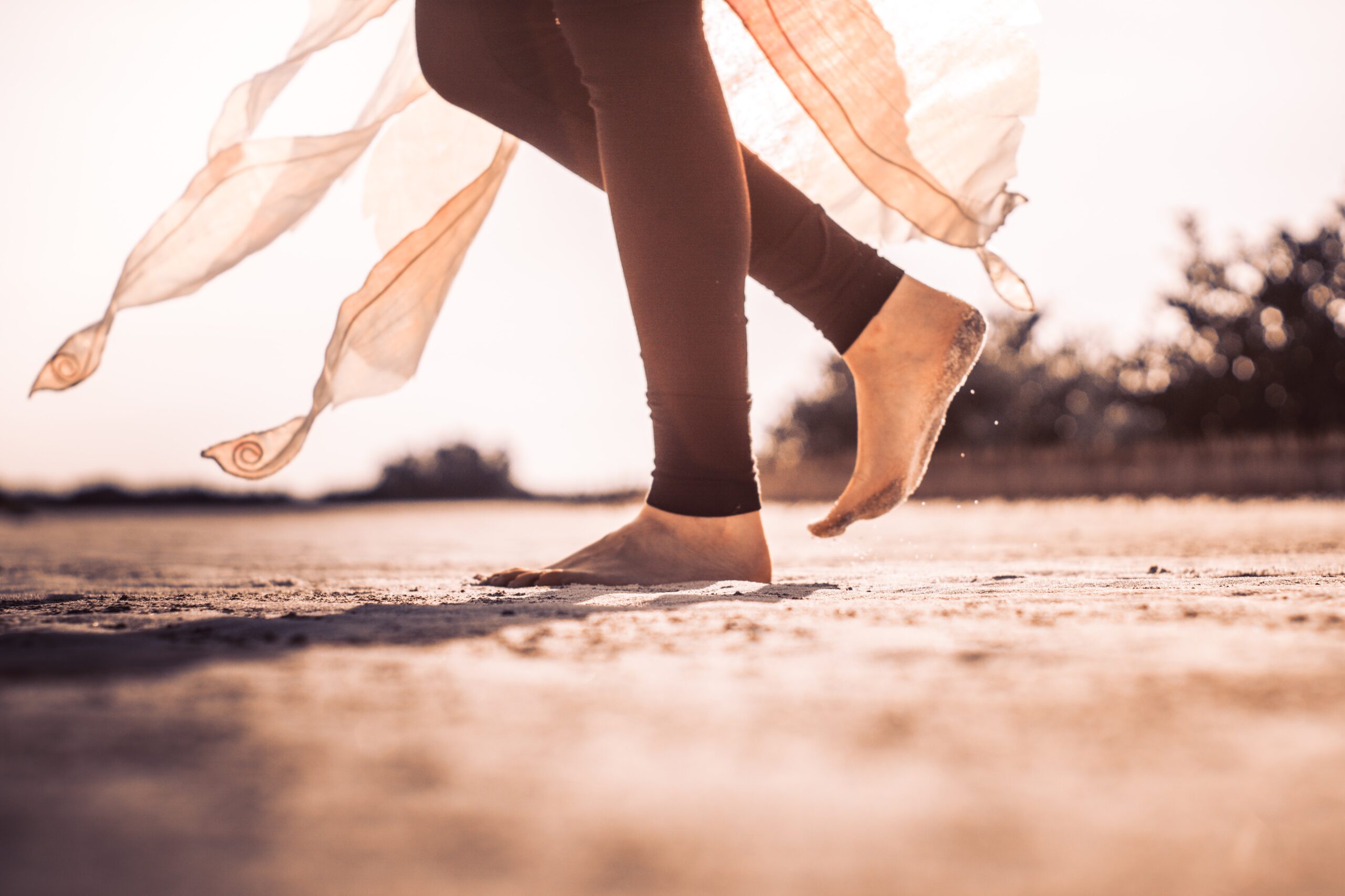 Image of feet walking on sand